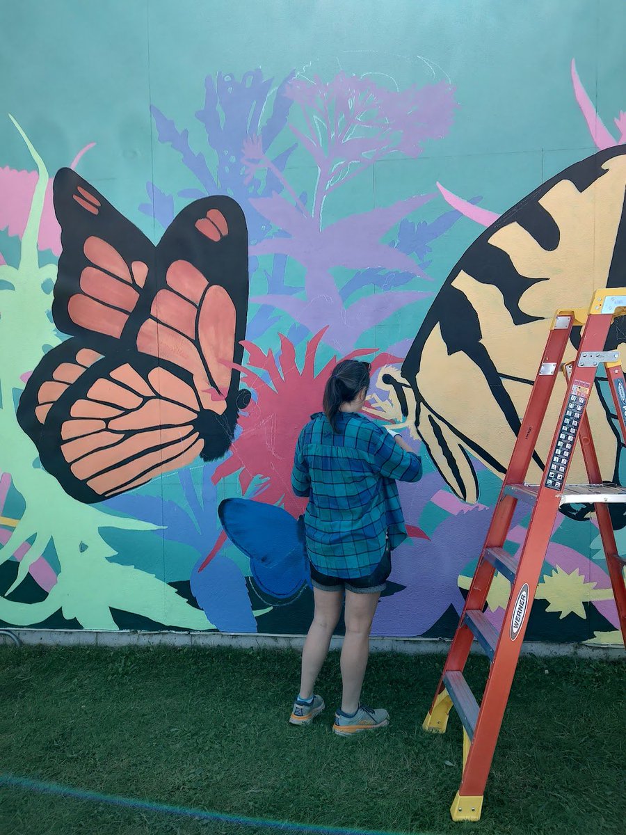 ArtsPentucket's tweet photo. The Merrimac Mural is looking better and better everyday! Since the teal background was painted, Jenn Houle has brought this piece of art to life with colorful and vibrant plants and butterflies! Thank you, Jenn, we can’t wait to see what the finished product will look like! https://t.co/KUhmHbdEvi