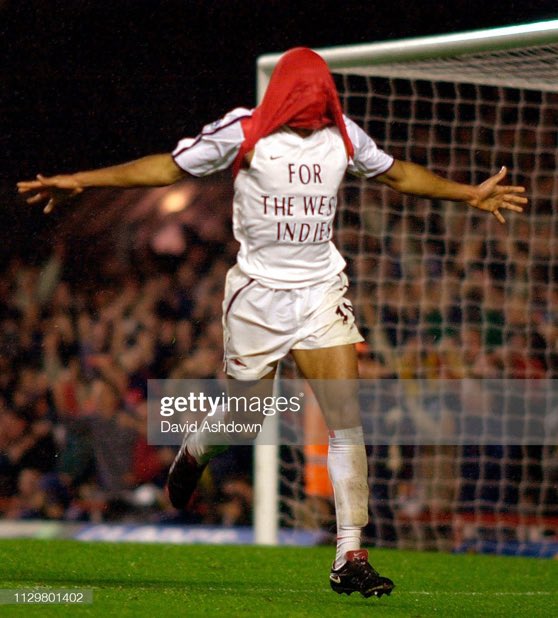 Thierry Henry pulls his shirt over his head after scoring against Manchester United, 2001.