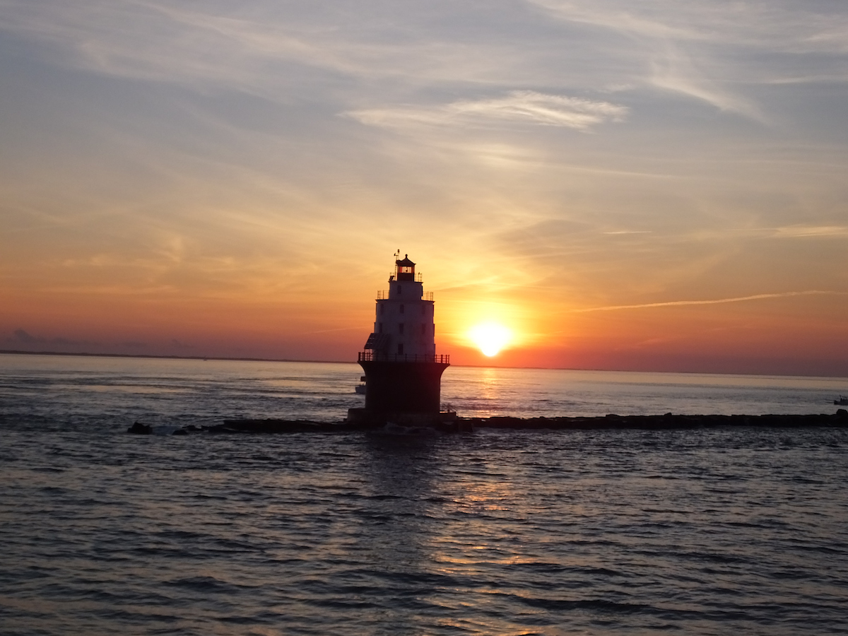 CMLFerry's tweet photo. Ahhh, Sunday sunsets! ☀️ Check out this breathtaking photo of the Harbor of Refuge Lighthouse - isn't it heavenly? 🤩 #cmlferry #sunsetsunday https://t.co/1EGjEUhLmZ