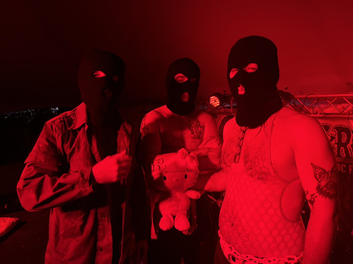 New Muddy Roots tradition- my kid finds the evilest looking people and gets them to pose with a custom made Hello Kitty backpack.