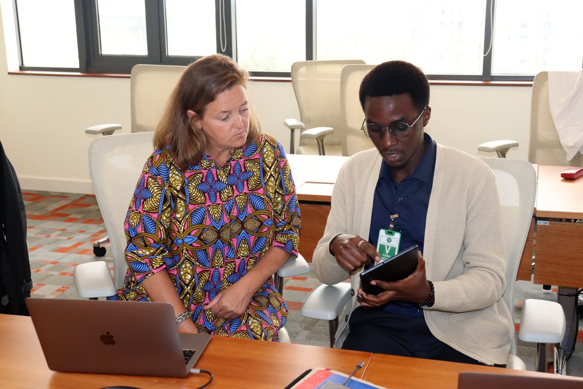 NursesMidwife's tweet photo. A software programmer from @mHealth_Kenya demonstrates the various capabilities of the #KeNum app to Stacey Meyers, the Global Community Impact Leader-EMEA @JNJGlobalHealth. https://t.co/3Xh5e2cWmv