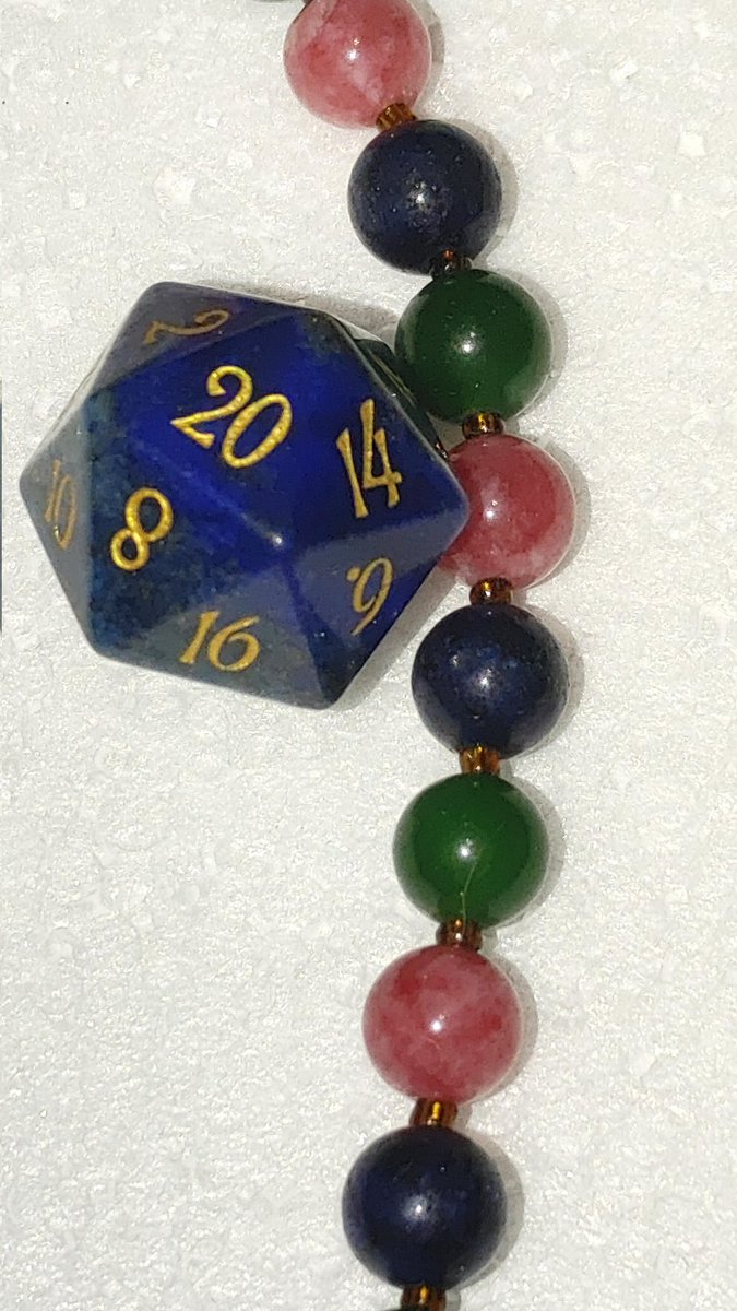 aletamosquito's tweet photo. Here is my lapis lazuli dice set from @urwizards along with a necklace I made using rhodochrosite, jade, and lapis lazuli beads. Lazurite, the blue mineral in the lapis is a member of the #sodalite group. #MinCup23 https://t.co/HGZMTE3XrE