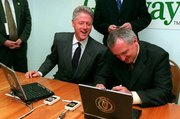 President Clinton (left) pictured with An Taoiseach (Irish Prime Minister) Bertie Ahern as they digitally sign an agreement on the Gateway's Fireant laptop computer on the use of electronic commerce on the internet at the Gateway Computer Factory in Coolock, Dublin, Ireland.