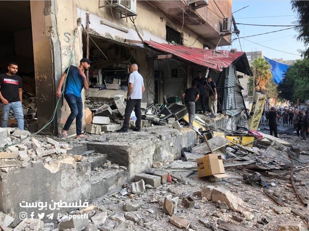 Anna_AnninaEl's tweet photo. After the invasion of Nour Shams refugee camp, Tulkarm, "Israel" leaves it in complete disaster. Blown up shops, destroyed infrastructure, Palestinian youth murdered. This is what the Palestinian people have to struggle with almost everyday. 
#DownWithOccupation
#DownWithIsrael https://t.co/6L45OKQQ1L