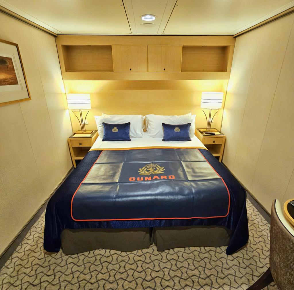 andyandkirstie's tweet photo. Kirstie taking a pic of our cabin on @cunardline QM2. As far as inside cabins go it was decent and had everything we needed for our short trip. #cunard #cruise https://t.co/BvrAfp53gu