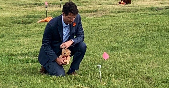 Michael_J_Matt's tweet photo. They found rocks. Nothing but rocks in those "mass graves" of indigenous children at residential schools across Canada. After a 2-year investigation and multiple excavations, not a single body of an indigenous child was found. Just rocks! The whole thing was a fake news story, exactly as we said at the time.  But this particular case of fake news led to 80 Christian churches in Canada being burned down. The good news? This photo of the Little Ferret becomes an iconic metaphor for the Deification of Stupid that is going on in the world today. A powerful "Catholic" politician, holding a teddy bear just right for the cameras to see, kneeling at a fake news grave, pretending to care about a genocide that never happened.  Meanwhile, the same idiot actively promotes the abortion and euthanasia genocide in Canada. You. Just. Can't. Make. THIS. STUPID. UP!