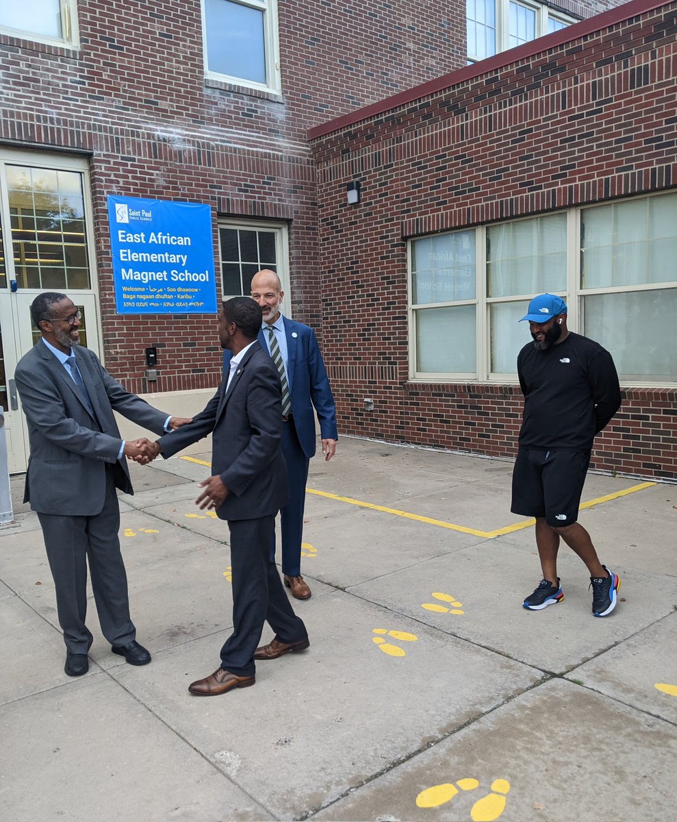 Principal Abdisalam Adam shakes hands with Mayor Melvin Carter, and Superintendent Joe Gothard and phy-ed teacher Kalid El-Amin are on hand, too, for the opening of St. Paul's new East African Elementary Magnet School.