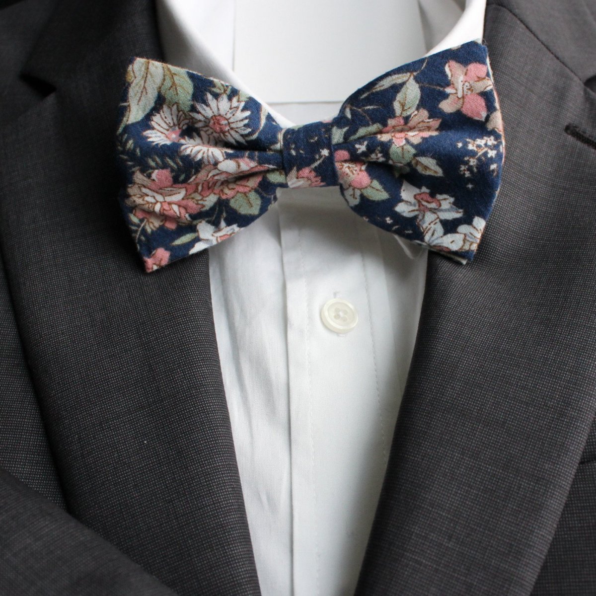 Dapper and dashing, with a twist of floral flair. Let your personality bloom with this unique accessory. #bluebowtie #bluewedding #bowties #bowtie #bowtiesarecool #bowtienation #bowtiestyle #bowtielife #bowtieready #mensstyle #menswear #mensfashion #groomsmen #groomswear #wedding