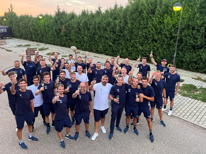 A shot of the riders and staff at the Vuelta a Espana raising a glass in a toast.