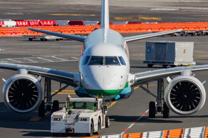 Head-on with the Pionair Embraer ERJ-190 E2 being pushed back for departure from Auckland Airport.