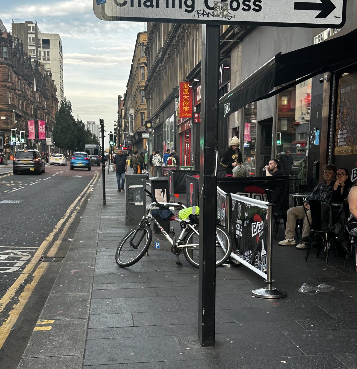 Bizarre street clutter in Glasgow. Huge pavement reduced to about 40cm width by seating, poles, bike racks and utility boxes.