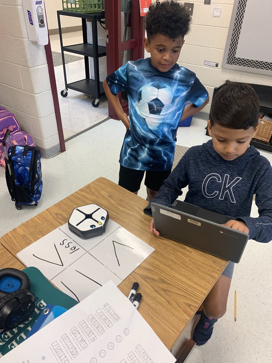 Coding fun! Students are coding their robots to compare numbers.