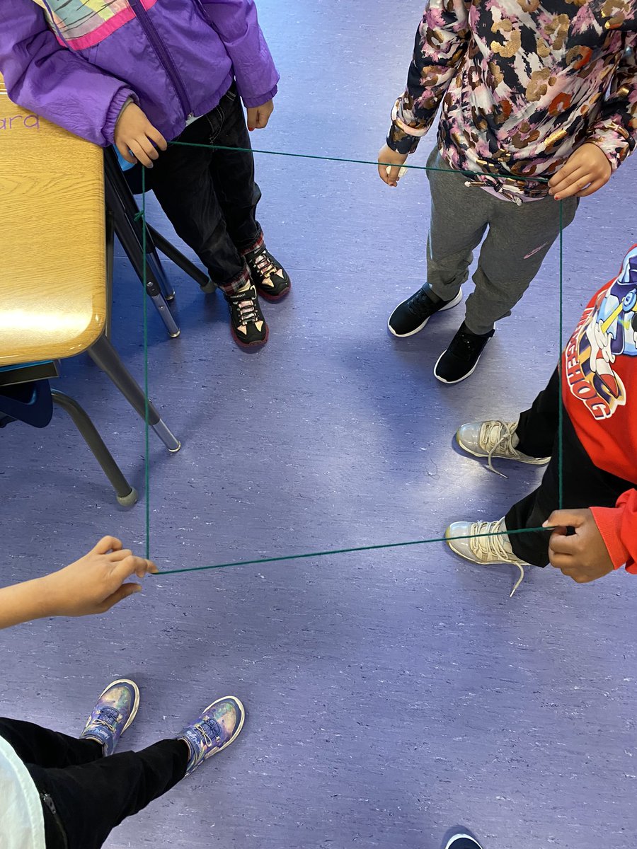 mrspaulitzki's tweet photo. We are building a math community by learning to talk about our ideas, listen to others, work together, and ask questions. Today, students worked in groups to make different shapes using a piece of yarn. Everyone had to be touching the yarn at all times. Awesome teamwork, 1A! https://t.co/0XDzou2D65