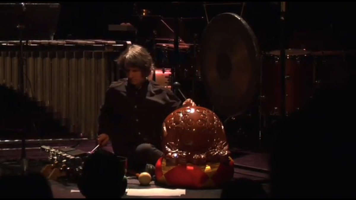 Imagine this music mixed with the sounds of aeroplane engines, ship whistles, and signals that come intermittently from the Thames outside the window.