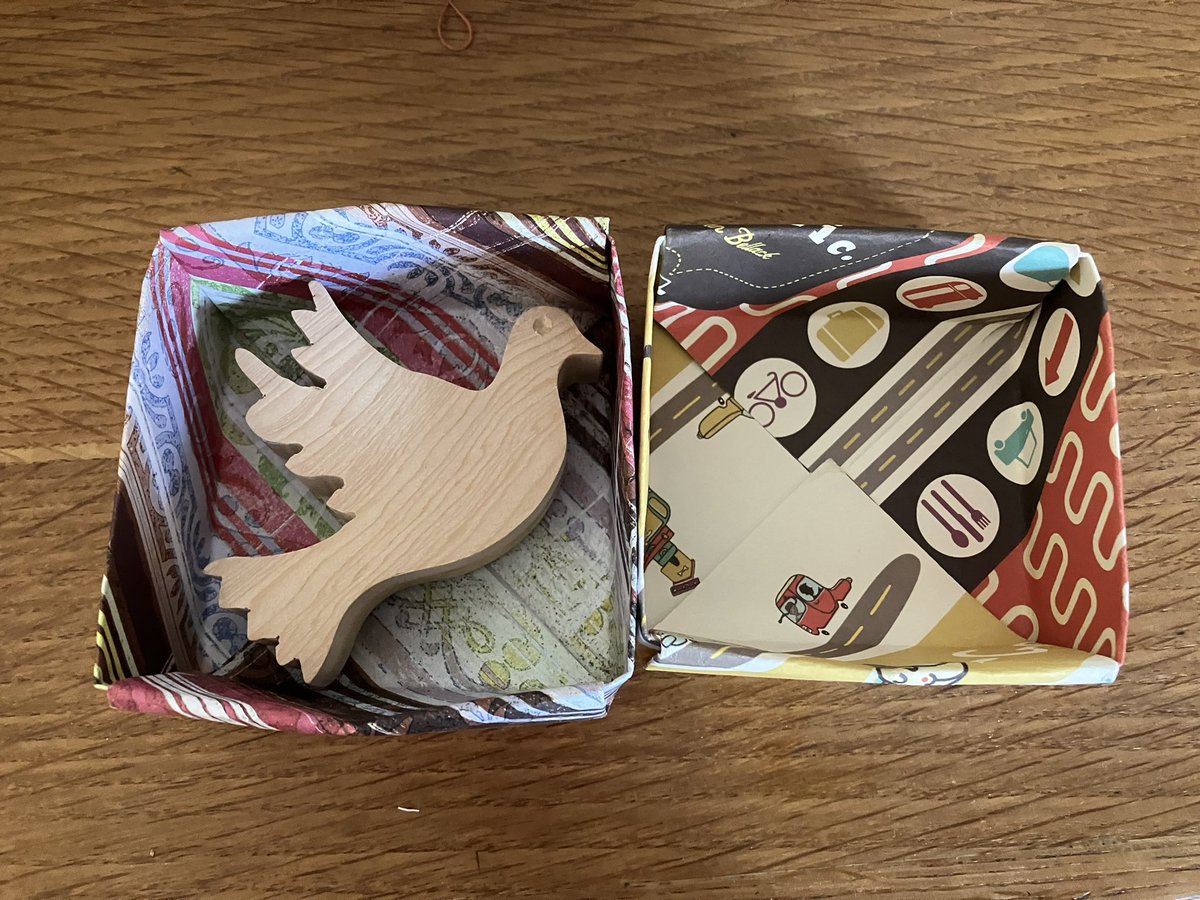 SallyKerson's tweet photo. Experimenting with #HandFolded #boxes for the #wooden #doves the creases aren’t perfect but trying to get the right size. Really like the look though and it’s much better than using #plastic bags and the #colourful #paper shows up the wood. https://t.co/pFjNqsszT8