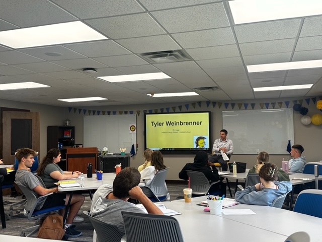 Tyler Weinbrenner, HHS/HMS Principal and Tabor College graduate, shared his passion for teaching with the ED 100 classes. <a href="/TaborCollege/">Tabor College</a>