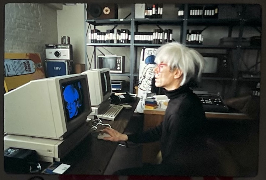 Andy Warhol at the Warhol Studios in New York City with two #𝑨𝑴𝑰𝑮𝑨 computers, photographed by Edward Judice for the AmigaWorld Magazine (Volume 2, Number 1, January/February 1986). This shot did not make it into the printed magazine.