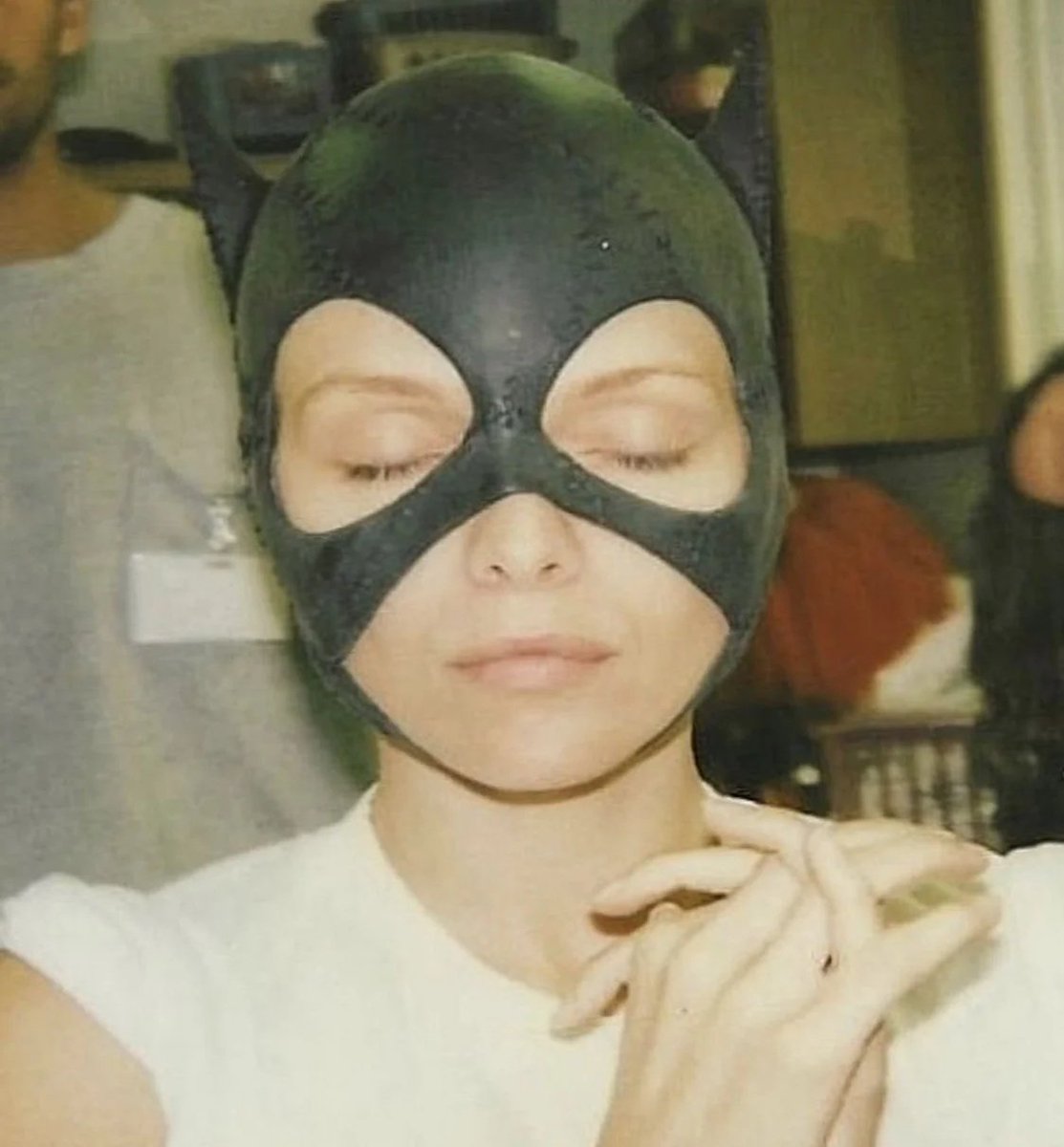 A behind the scenes photo of Michelle Pfeiffer trying on her Catwoman mask for Tim Burton's BATMAN RETURNS (1992).