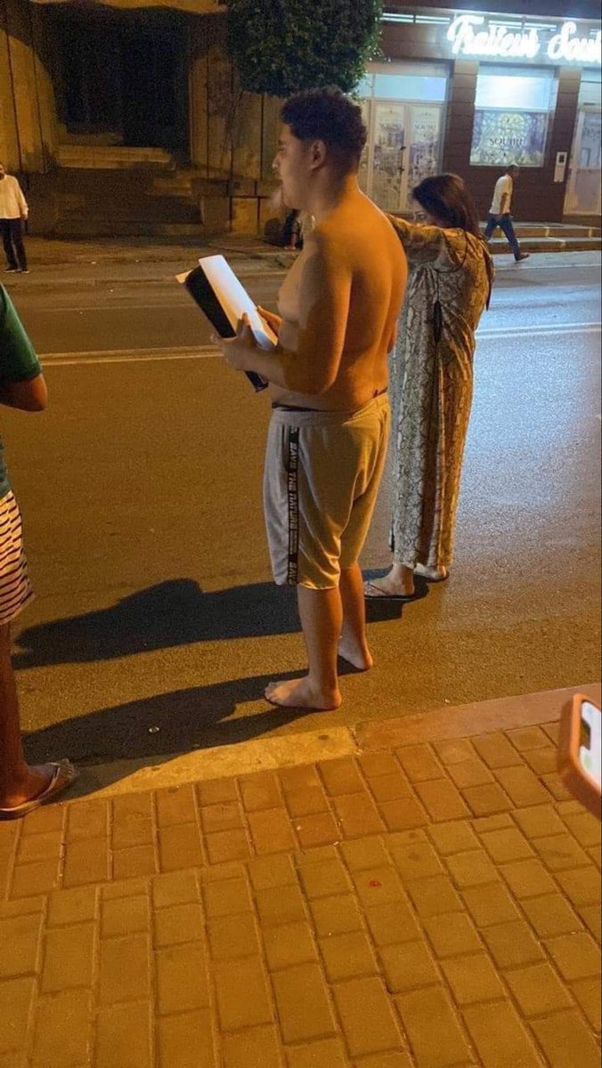 TheInsiderPaper's tweet photo. PHOTO: Shirtless man left behind everything and ran outside only with PlayStation 5 after massive earthquake hits Marrakesh, Morocco https://t.co/ueeJzREQIG
