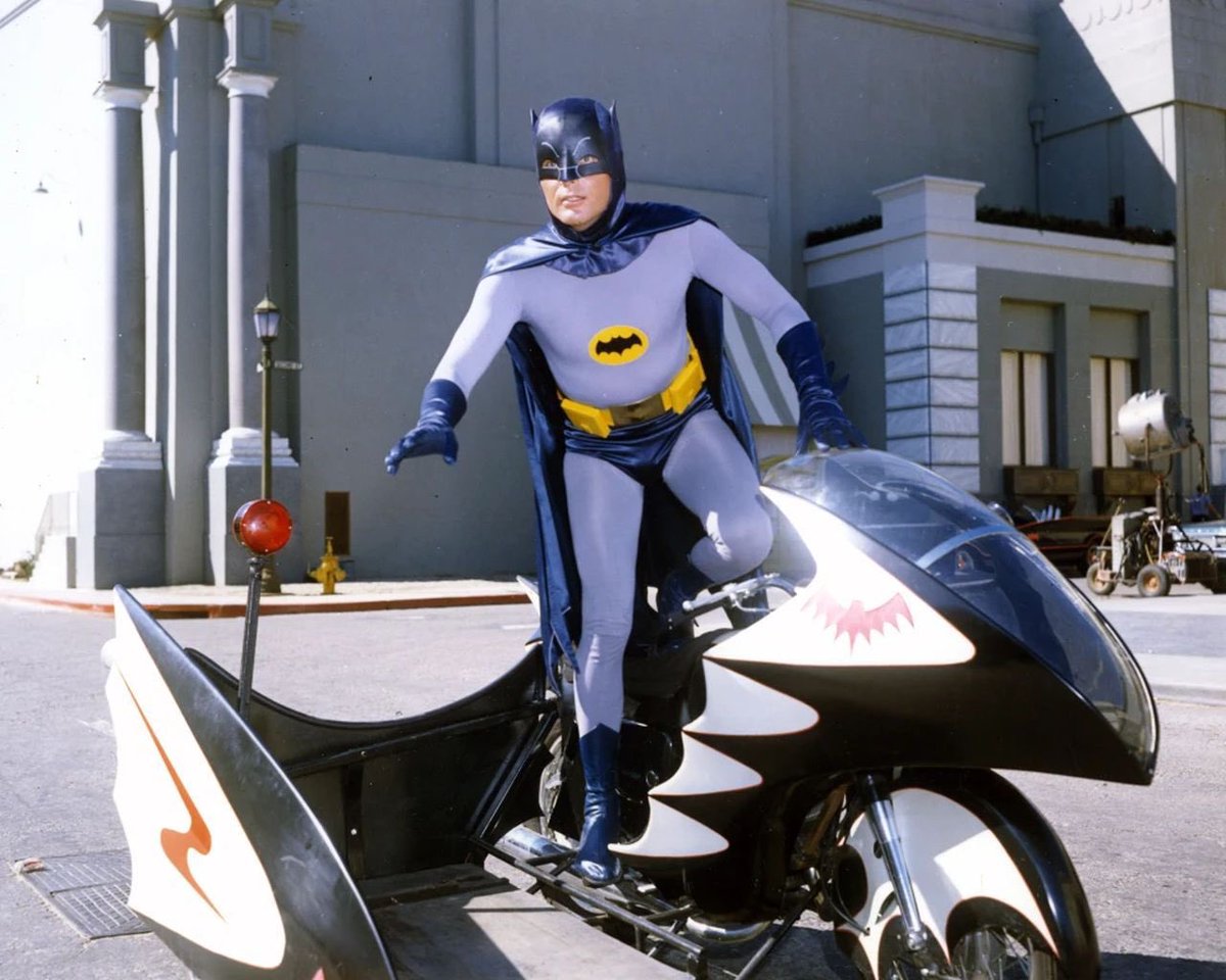 Adam West as Batman on the Batcycle