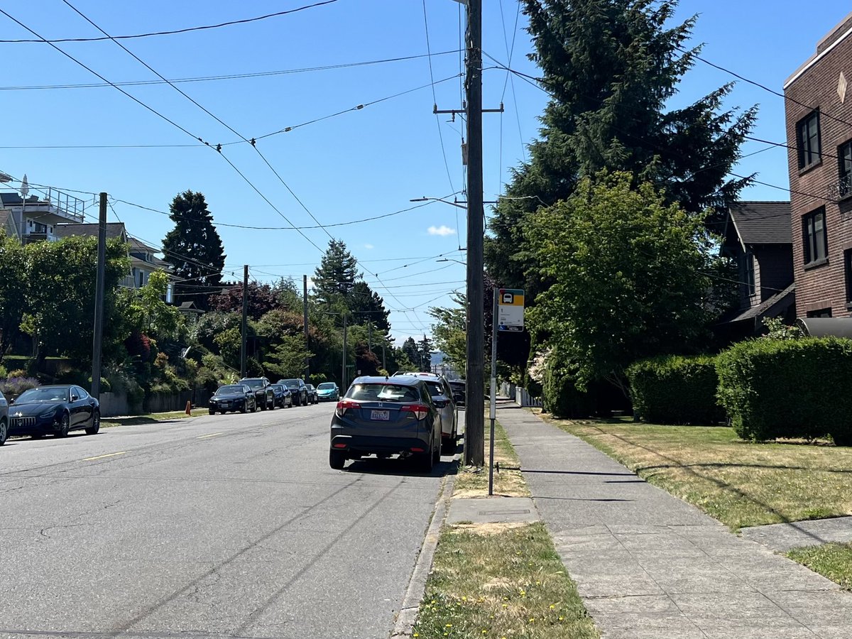 Qagggy's tweet image. Residential collector arterial, Seattle vs. a Dutch suburb. Both have bus stops, parking, and two lanes of traffic.