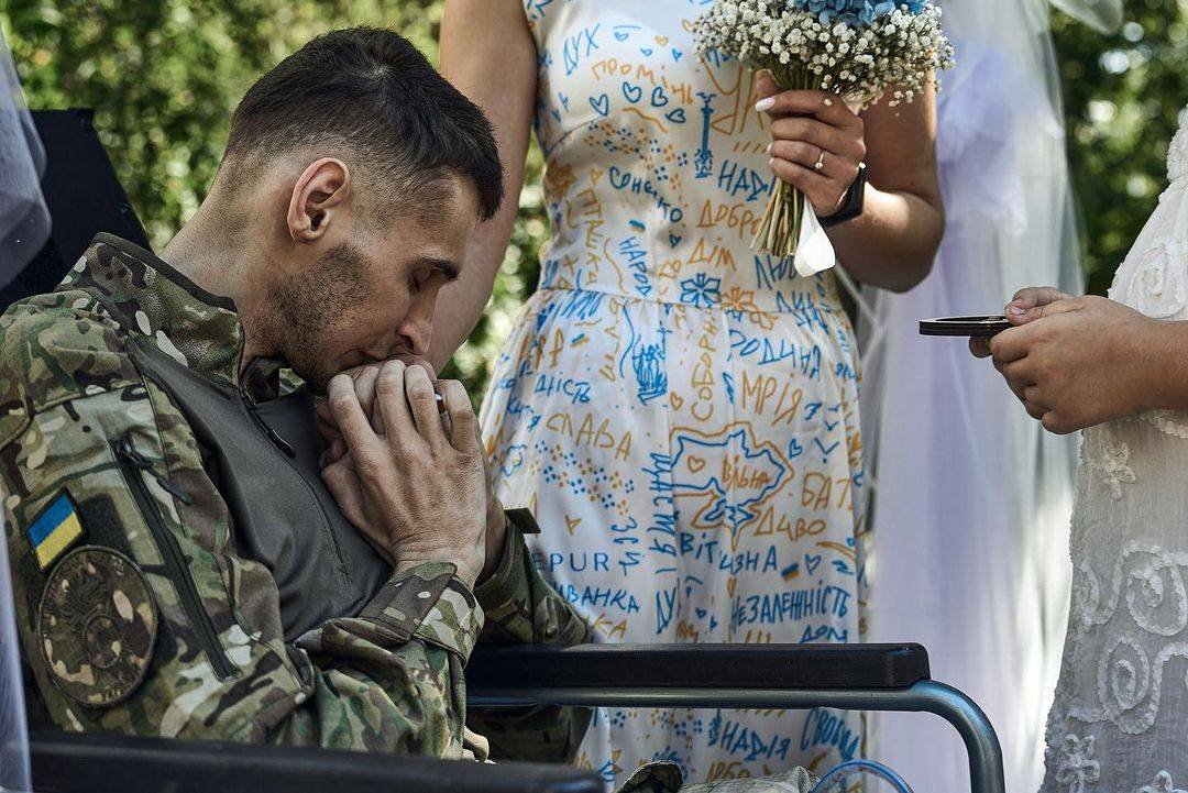 DefenceU's tweet photo. Vladyslav and Anna had planned for their wedding to take place at the end of February 2022. But when russia’s full-scale invasion began, Vladyslav went to the front lines. They moved their wedding date to August 7, 2023. However, Vladyslav was severely injured just a few days before that. The doctors weren’t sure that he would survive. Miraculously Vladyslav regained consciousness just in time for their wedding - on the day before. Vladyslav and Anna decided not to gamble with fate a second time, and took their vows in a military hospital as soon as Vladyslav's condition permitted.
Don't postpone your happiness until some “perfect” future date. In war or in peace, the perfect moment is always now. 

Story, photo by @Liberov