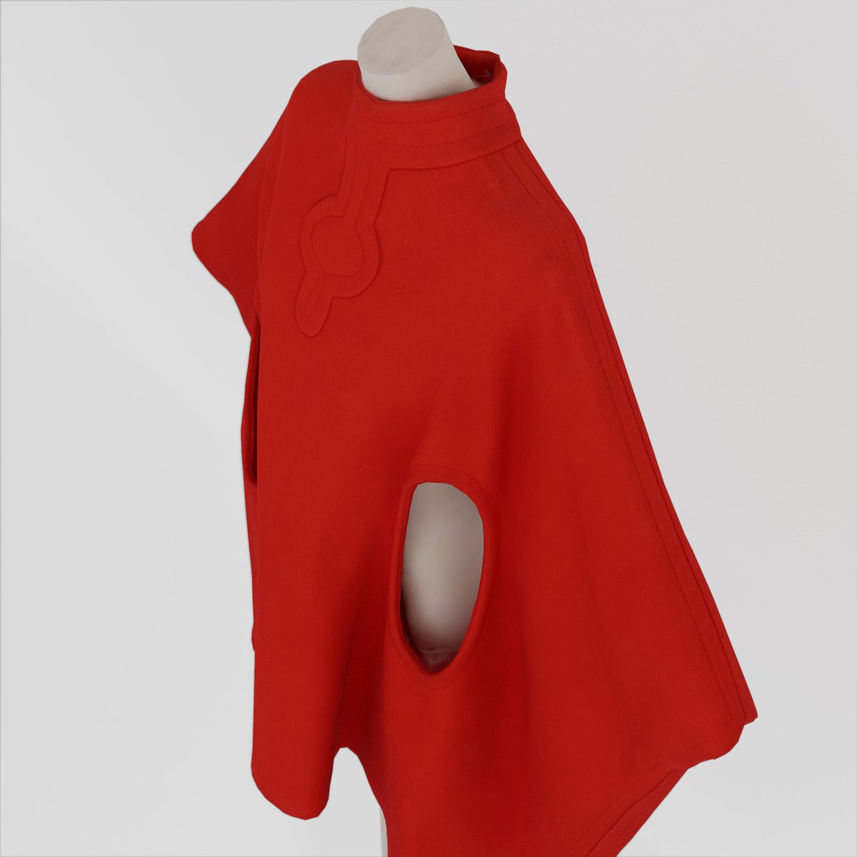 The groundbreaking "Cosmocorps Look" from 1966, a vision of what men and women would wear on the moon 50 years into the future, is one of the designer's most iconic pieces, characterized by bold, geometric details using enamel, vinyl, zips, metallics, and more.

 This vivid red