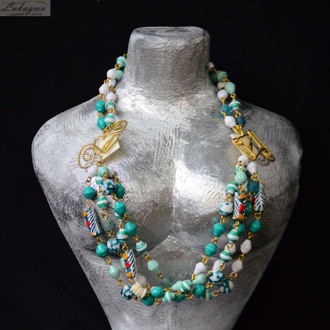 Sophistication Redefined: Discover Our Collection of Turquoise Layered necklace #Paperbead. Paper beads, hand painted #Segibeads and the famous gas recycled from bottles. Picture rocking this with your white linen outfit as you stroll down the ocean! #africanart #africanjewelry