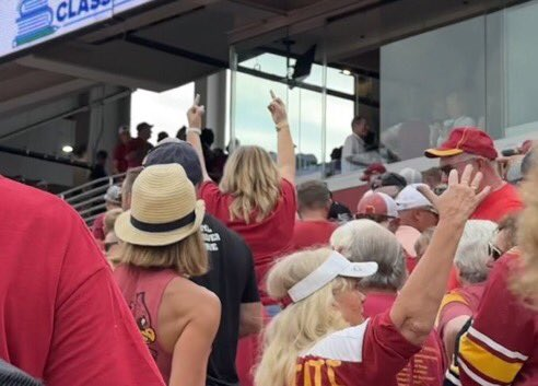 New photos are emerging showing the crowd at an Iowa football game flipping off Trump as he waved from behind glass.