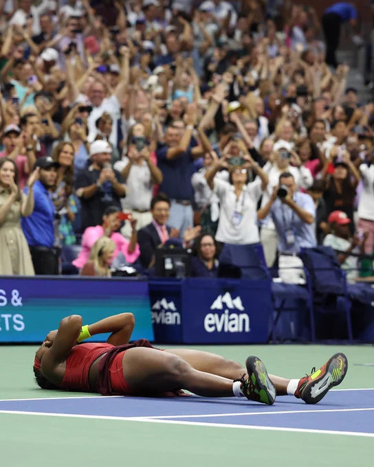 Image:  Coco Gauff laying on the floor after her US Open finals win.