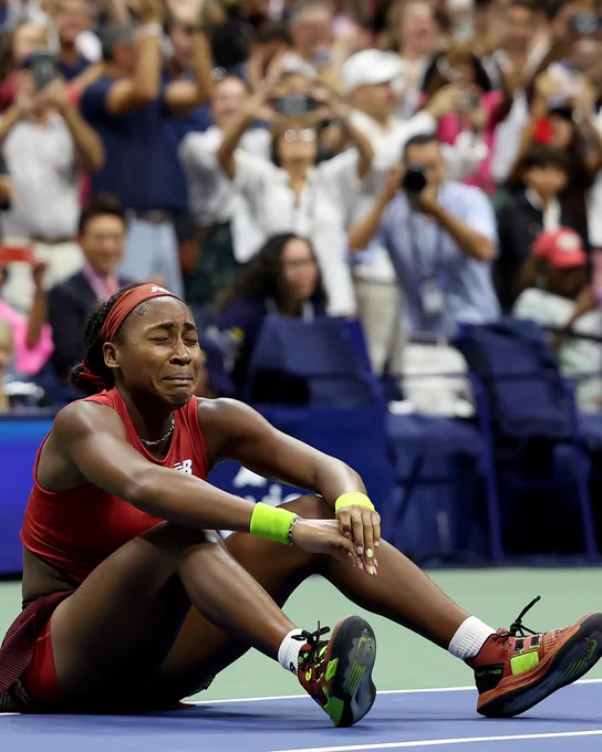 Image: Coco Gauff sitting on the floor crying after winning her first US Open final.