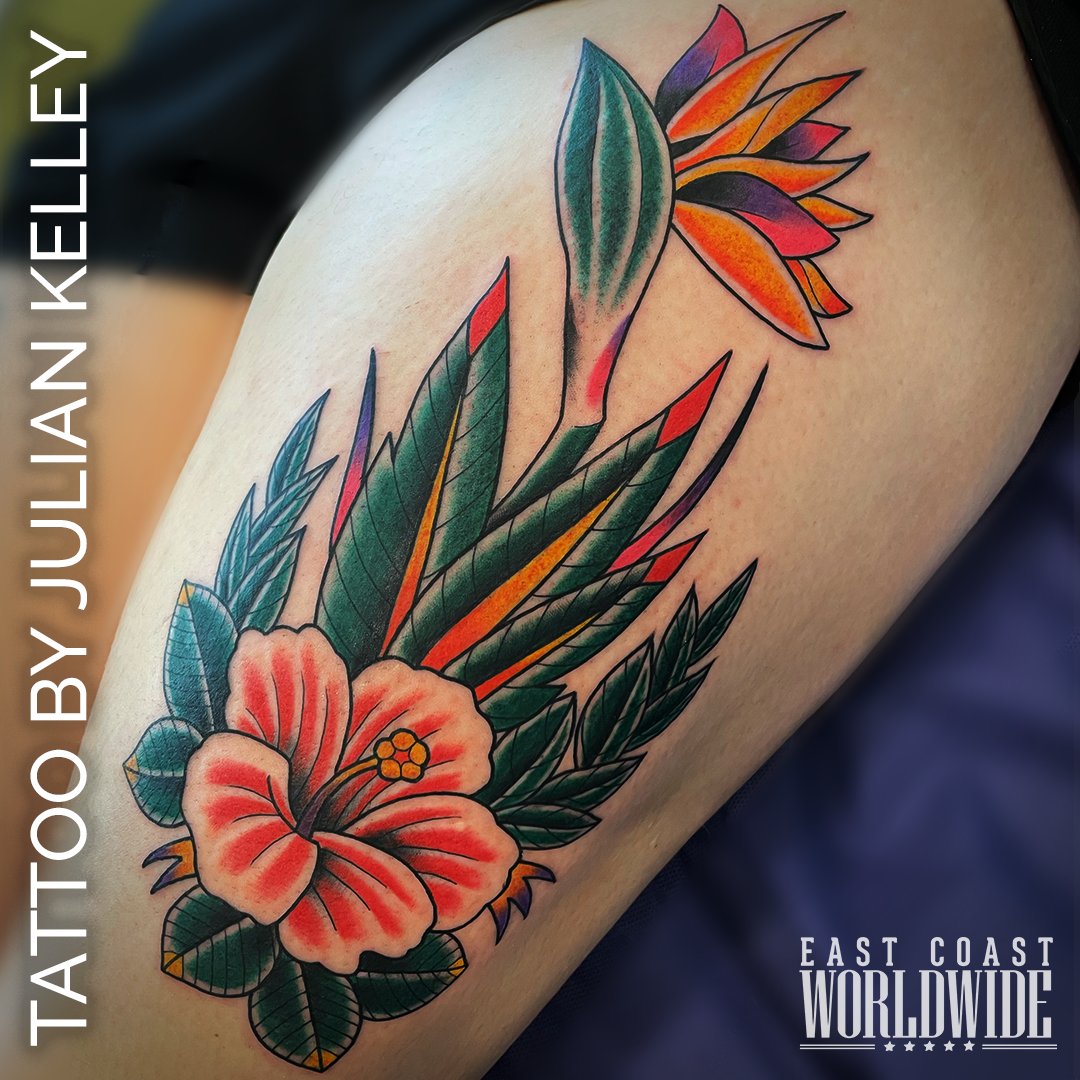 Check out this bright and colorful flower and leaves tattoo created by Julian Kelley. #checkout #flowerstyle #tattoo #colorful