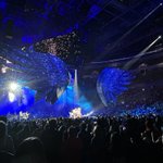 wings above the stage under blue lights