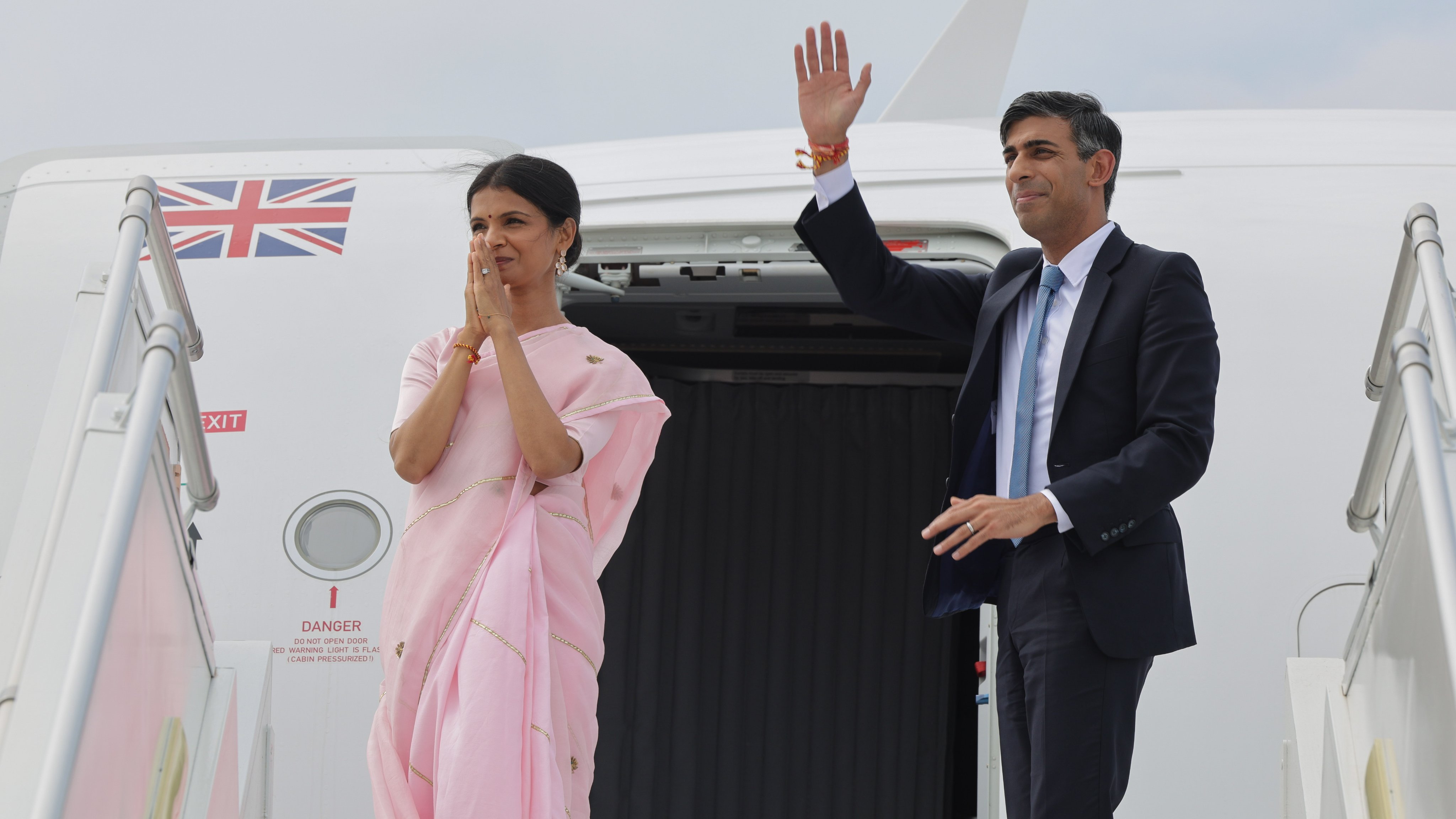 Prime Minister Rishi Sunak and his wife Akshata Murty board a plane as they leave the G20 in India