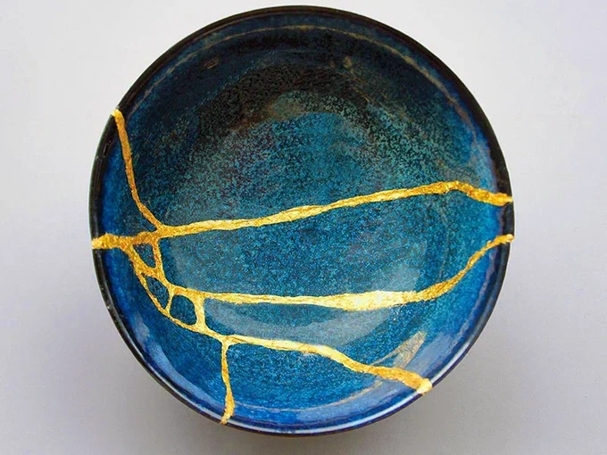 Really_Hamilton's tweet photo. Fun Fact: The origins of Kintsugi: As the story goes, a 15th-century military ruler, Ashikaga Yoshimasa, sent one of his tea bowls back to China to be repaired.  

When it was returned, he was disappointed with the finished result and asked a local craftsman to find a more aesthetically pleasing method of repair.  

The idea that it celebrates fragility, building strength and resilience, and taking pride in the imperfect really makes me a fan. 

Plus it really does make this bowl even more lovely.
