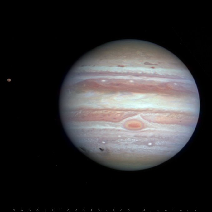 In this image there's Jupiter after the impact with comet Shoemaker–Levy 9. Black areas on the atmosphere are visible on the southern hemisphere as a result of the impact. The rest of the atmosphere appears with its typical bands orangish/whitish and the Great Red Spot is visible under the equator. 