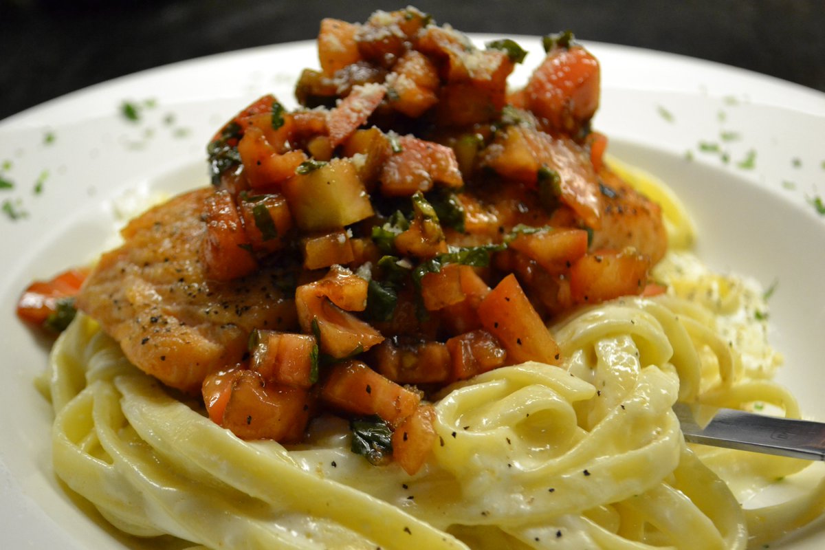 Grilled Salmon with fresh basil salsa cruda atop creamy fettuccine alfredo.  The perfect blend of flavors and textures that will leave you wanting more!
#SeafoodLover #DeliciousDinner #Salmon