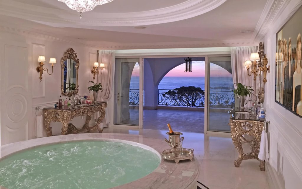 Askash's tweet photo. The most expensive house in #SouthAfrica is for sale in Camps Bay, Cape Town - it’s listed online for a selling price of $35 million - that’s almost R700 million at today’s exchange rate

The single family home includes:

🏛️ 8 bedrooms
🏛️ 13 bathrooms
🏛️ Year built: 2014
🏛️ Size under roof: 3 133m2
🏛️ Size of terraces: 1 190m2
🏛️ House name: Casablanca 
🏛️ Location: 30 Geneva Drive, Cape Town, Western Cape

Unique features: gym, squash court, massage room, sauna for 12 people, wine cellar, whiskey bar, library, movie theatre with 18 seats, billiard room, Olympic lap pool, parking garage for 14 cars as well as wash bays 

Sale price is one thing. I wonder if the owner would object if the municipality actually valued this mansion at its current selling price?🤣
