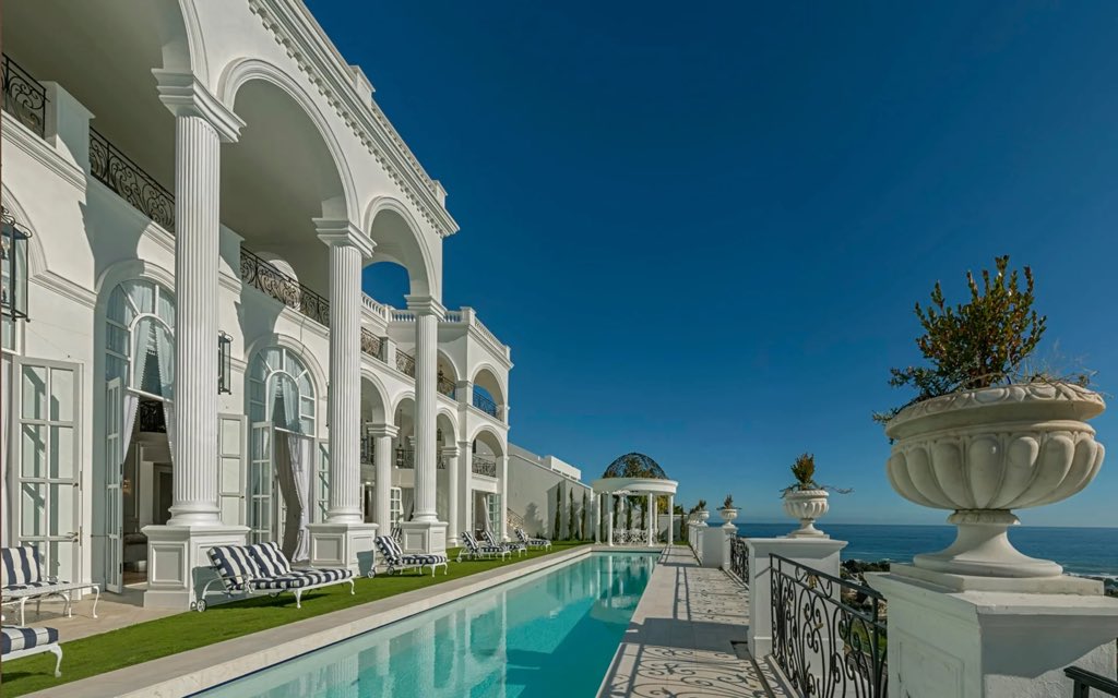 Askash's tweet photo. The most expensive house in #SouthAfrica is for sale in Camps Bay, Cape Town - it’s listed online for a selling price of $35 million - that’s almost R700 million at today’s exchange rate

The single family home includes:

🏛️ 8 bedrooms
🏛️ 13 bathrooms
🏛️ Year built: 2014
🏛️ Size under roof: 3 133m2
🏛️ Size of terraces: 1 190m2
🏛️ House name: Casablanca 
🏛️ Location: 30 Geneva Drive, Cape Town, Western Cape

Unique features: gym, squash court, massage room, sauna for 12 people, wine cellar, whiskey bar, library, movie theatre with 18 seats, billiard room, Olympic lap pool, parking garage for 14 cars as well as wash bays 

Sale price is one thing. I wonder if the owner would object if the municipality actually valued this mansion at its current selling price?🤣