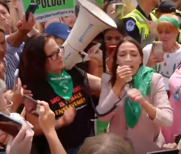 @Serenityin24 Remember the SCOTUS protests?
That's Sunsara Taylor of the rev coms holding AOC's megaphone for her.
riseup4abortionrights is a rev com subsidiary.
There is no coincidence.