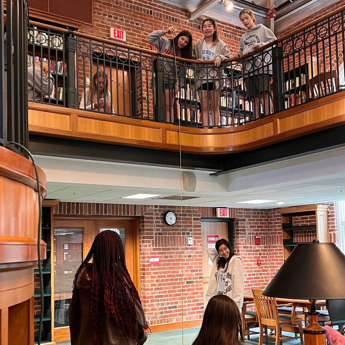 MadHuffLib's tweet photo. Dr. Guzman's Physics class came to do some #MadeiraScience in the #MaderiaLibrary this morning - dropping tennis balls from the balcony to calculate acceleration due to gravity. https://t.co/JuMs2Ojoqu