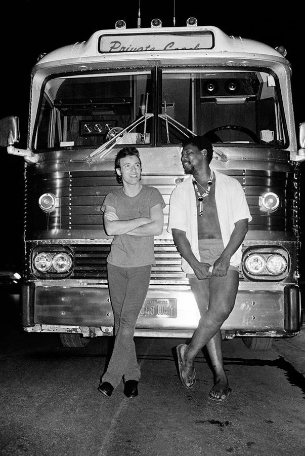 Bruce Springsteen and Clarence Clemons in front of Tour Bus, 1978. Photo by Lynn Goldsmith