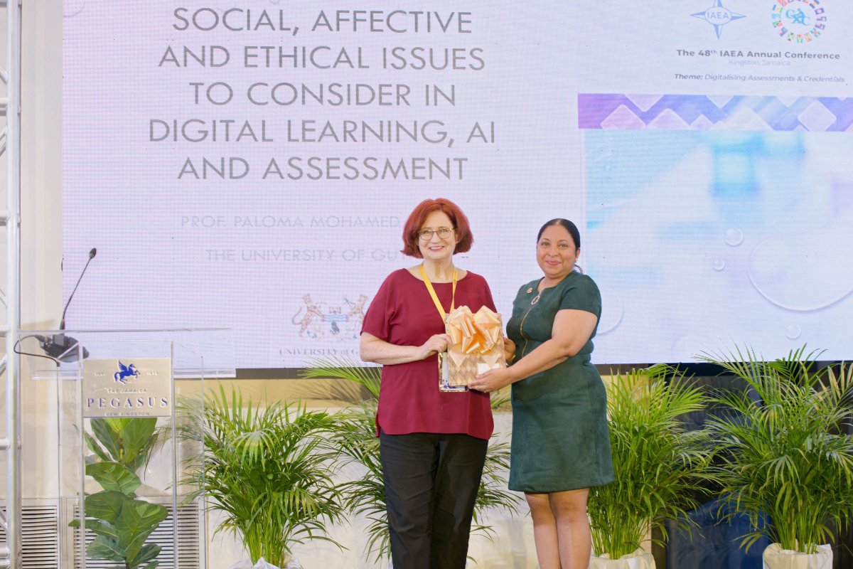 iaea2023's tweet photo. Dr Mary Pitoniak, President of the IAEA (left), makes a presentation to Professor Paloma Mohamed-Martin after her keynote speech at the 48th IAEA Annual Conference hosted by CXC®. https://t.co/gibmJZsZN4