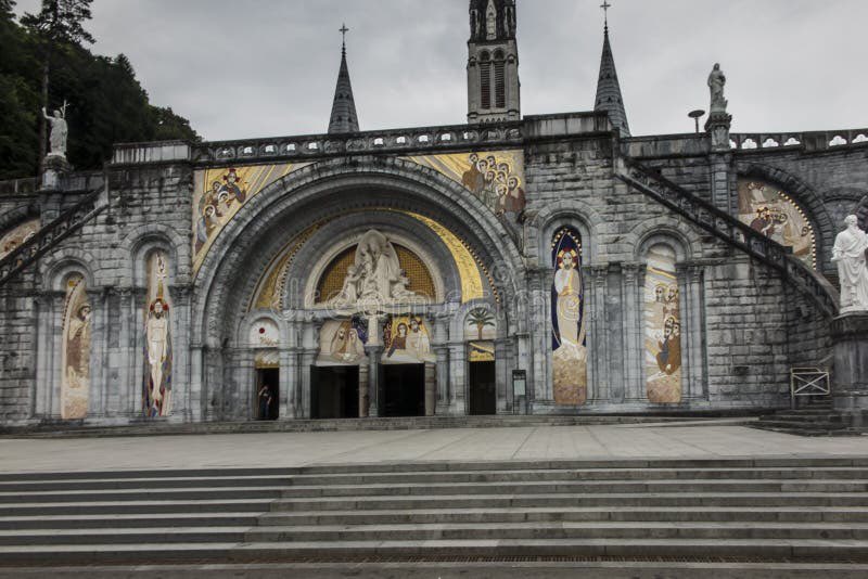 ThomasBasic's tweet image. Getting into the story of the Lourdes apparition, vibing with the positive message and appearance to a poor little girl, look up the sanctuary, love how it looks like a Disney princess castle in the French countryside, wait…enhance…Rupnik art plastered on front. Remove 😩