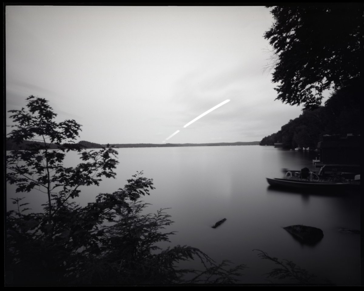 Pinhole of the full moon rising over Lake of Bays, Ontario in August. I had to cut it short because a storm rolled in (Harman TiTAN 8x10, @ILFORDPhoto HP5)