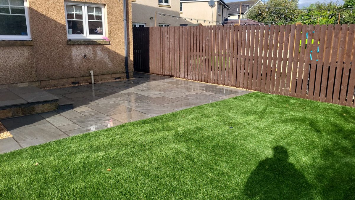 A sleek, tidy, &amp; low-maintenance garden project in #Kintore. We're loving the rich earthy tones of #IndianSandstone here, which pairs perfectly with the lush and evergreen artificial turf.🌿

#artificalgrass #landscapegardener #indiansandstone #paving  #aberdeen
