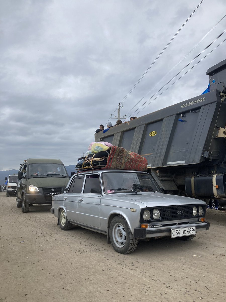 Cars and trucks carrying refugees out of Karabakh