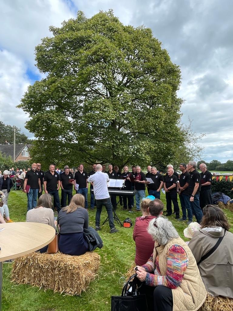 Here’s a pic of the choir performing at The Ashley Festival last Saturday, sporting our choir polo shirts!
