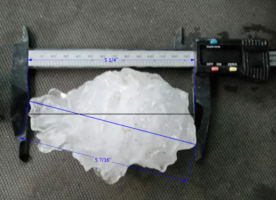 Photo of large hailstone roughly 5.25” in diameter measured via calipers from storm chaser Dan Fitts.