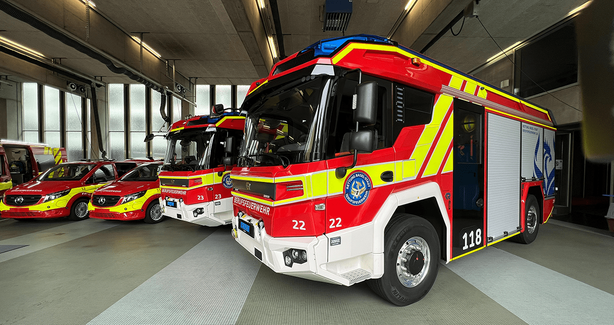 a row of fire trucks in a garage